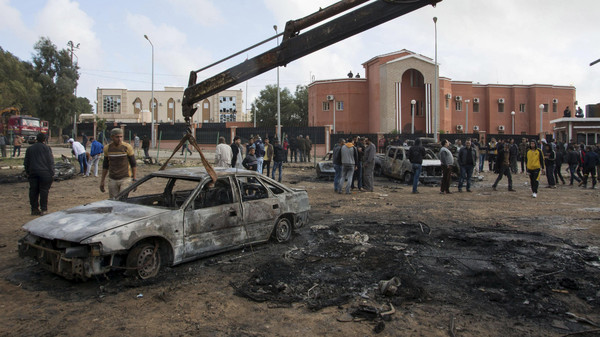 The burnt-out remains of a car is removed from a road at the site of a bomb blast in Shahat, eastern Libya, November 9, 2014. 