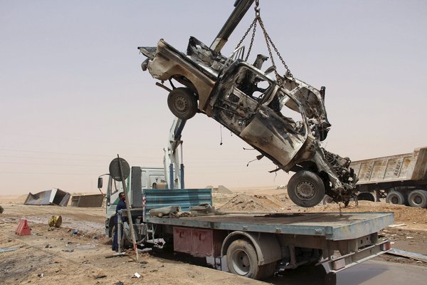 Wreckage of a vehicle after an attack by a suicide car bomber at a checkpoint near Misurata, Libya in May. The Islamic State claimed responsibility for the attack. Credit Reuters