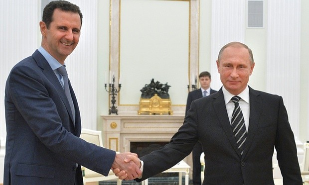 Vladimir Putin shakes hands with Bashar al-Assad in the Kremlin in October. Photograph: Alexei Druzhinin/AP