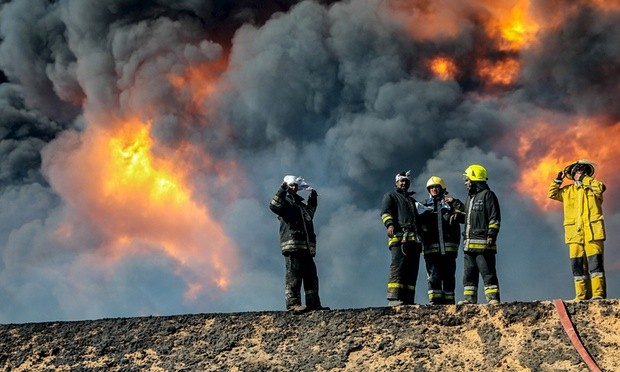 Firefighters try to extinguish an oil tank blaze after Isis militants attacked Ras Lanuf and the nearby terminal of Es Sider. Photograph: Reuters