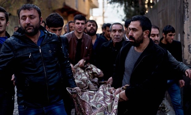 Kurds carry the body of a man killed during fighting with security forces in Sirnak, south-eastern Turkey, on Sunday 10 January. Photograph: Refik Tekin/EPA