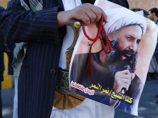 A Shia protester carries a poster of Sheikh Nimr al-Nimr during a demonstration outside the Saudi embassy in Yemen during October last year. (Khaled Abdullah-Reuters)
