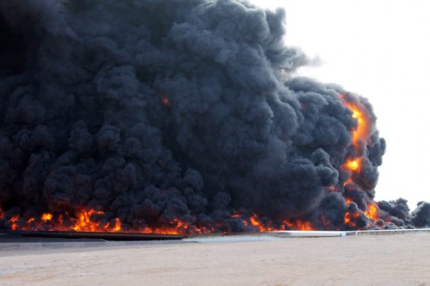 In a file photo from December 2014, smoke rises from a large fuel depot fire during fighting in Es Sider, Libya. PHOTO: STRINGER/EUROPEAN PRESSPHOTO AGENCY