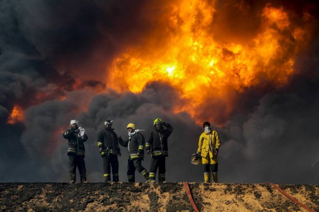 Firefighters trying to put out a fire in an oil tank in the port of Es Sider, Libya, on Jan. 6. The fires were extinguished over the weekend and now officials are trying to sell oil stored at the neighboring port of Ras Lanuf abroad. PHOTO: REUTERS