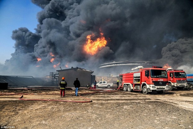 Firefighters extinguished two fires at oil storage tanks at Libya's Ras Lanuf terminal on Monday, but blazes continued at five tanks in the nearby port of Es Sider at the same time