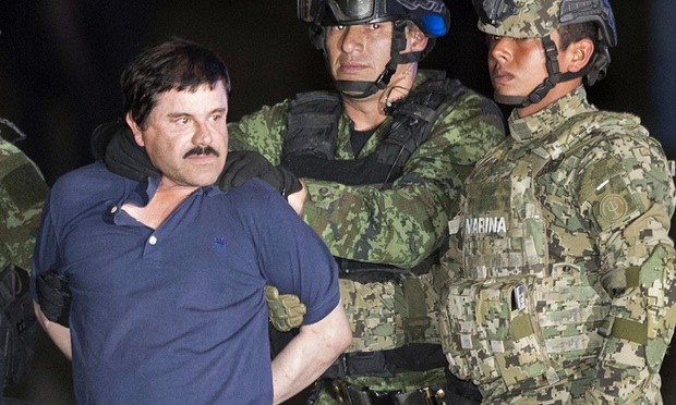 Joaquin ‘El Chapo’ Guzman is publicly escorted to a helicopter in handcuffs by Mexican soldiers and marines at a federal hangar in Mexico City on Friday. Photograph: Eduardo Verdugo/AP