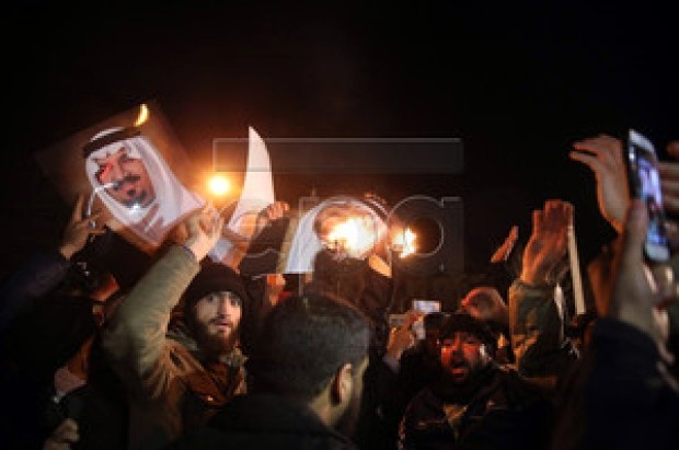 Protesters in Tehran burn pictures of a member of the Saudi royal family in front of the Saudi Arabian embassy. (EPA-MOHAMMAD REZA NADIMI)