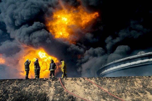  Firefighters battled a blaze at an oil tank in the Libyan port city of Es Sider during a series of attacks last month on the country's oil industry by Islamic State extremists. Photo: Reuters 