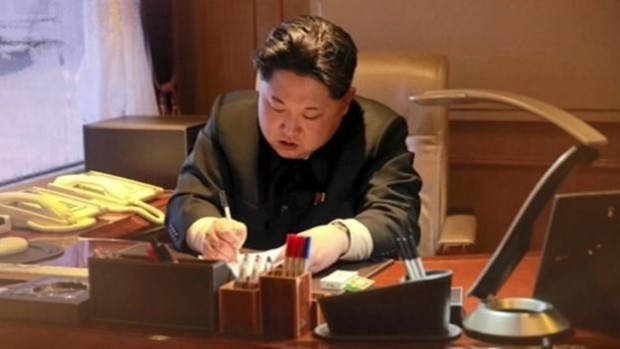 Kim Jong-un is shown signing-off on the rocket launch | Reuters