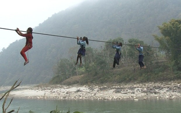 Schoolgirls cross Trishuli River via a rope-bridge each day  Photo: Manish Duwadi / Barcroft India