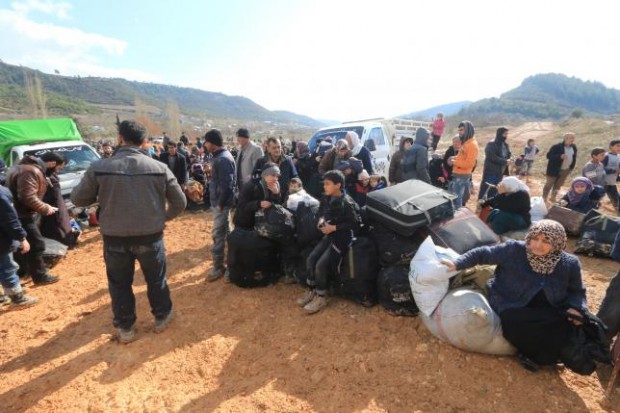 Internally displaced Syrians fleeing advancing pro-government Syrian forces wait near the Syrian-Turkish border after they were given permission by the Turkish authorities to enter Turkey, in Khirbet Al-Joz, Latakia countryside February 2, 2016. REUTERS/AMMAR ABDULLAH