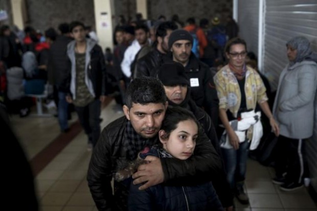 Refugees and migrants line up to receive a meal inside a terminal, moments after arriving aboard the Tera Jet passenger ship at the port of Piraeus, near Athens, Greece, February 10, 2016. REUTERS/ALKIS KONSTANTINIDIS