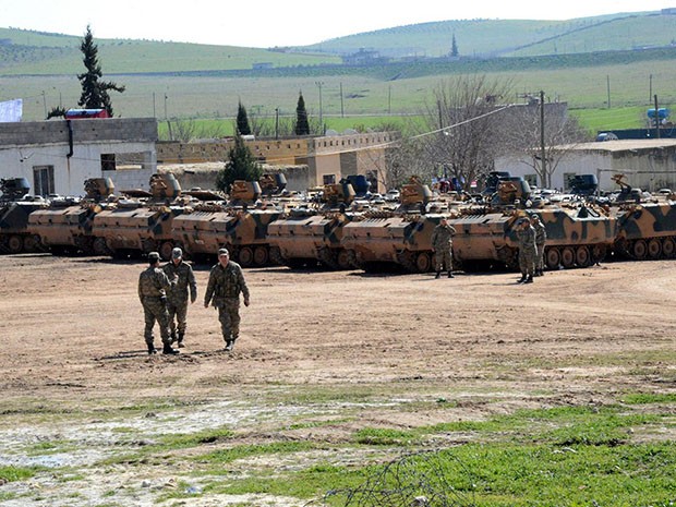 Turkish Army vehicles and tanks wait near the Syrian border ILYAS AKENGIN/AFP/Getty Images