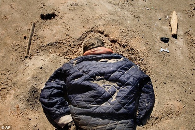 The body of a drowned migrant lay in the sand on a beach in Tripoli yesterday. At least 17 bodies have been recovered after a boat sank off the coast  Read more: http://www.dailymail.co.uk/news/article-3514736/Now-thousands-enter-EU-different-route-crackdown-Turkey-migrants-make-trip-Libya-Italy.html#ixzz44Pm0mpYs Follow us: @MailOnline on Twitter | DailyMail on Facebook 