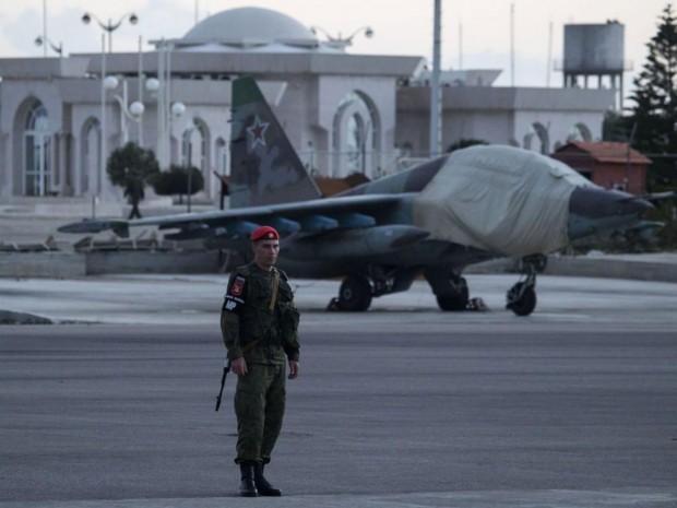  A Russian soldier guards a jet parked at Hemeimeem air base in Syria. Russian warplanes have mostly stayed on the ground since the cease-fire began AP 