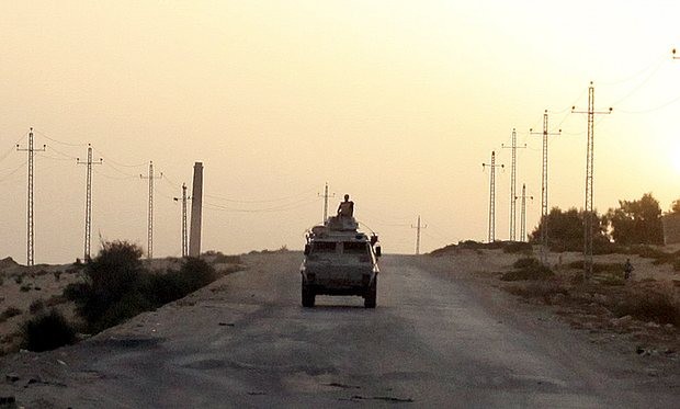 An Egyptian military vehicle on the road in Sinai. Isis has claimed responsibility for the attack on a security checkpoint in the area that killed at least 13. Photograph: Asmaa Waguih/Reuters