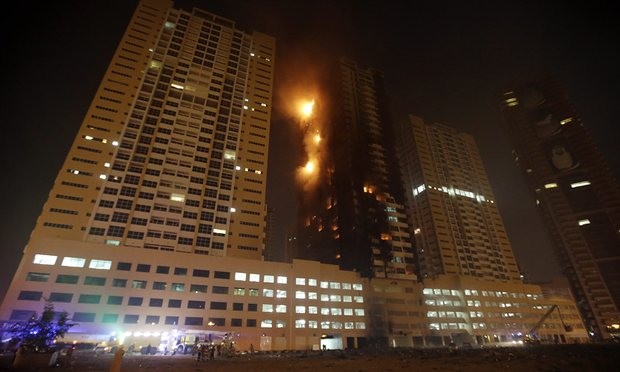 Members of the Civil Defense and fire services try to extinguish a fire at residential buildings at al-Sawan area in the Gulf emirate of Ajman. Photograph: Ali Haider/EPA