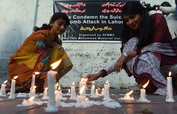 Karachi residents light candles to pay tribute to the victims of the 27 March suicide bombing in Lahore. Photograph: Asif Hassan/AFP/Getty Images