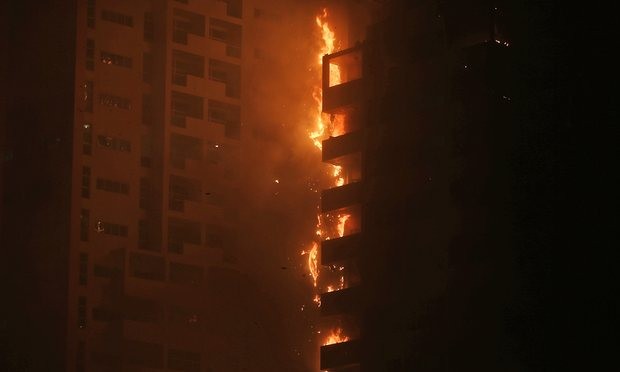 Fire and smoke billow from the high-rise building in Ajman. Photograph: Kamran Jebreili/AP