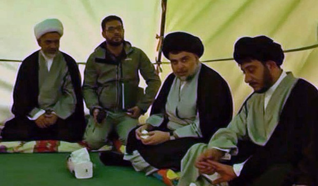 A handout picture provided by the press office of Iraqi cleric Moqtada Sadr shows him (2nd from R) sitting in a marquee as he begins a sit-in protest inside Baghdad's fortified "Green Zone" on March 27, 2016. Sadr wants Prime Minister Haider al-Abadi to enact reforms tackling corruption and announce a technocratic government to replace the current cabinet of party-affiliated ministers. The symbolic move by the young Shiite cleric comes after thousands of his supporters have been camping outside the restricted area's entrances for more than a week. / AFP / MOQTADA SADR'S PRESS OFFICE / STR / === RESTRICTED TO EDITORIAL USE - MANDATORY CREDIT "AFP PHOTO / HO / MOQTADA SADR'S PRESS OFFICE" - NO MARKETING NO ADVERTISING CAMPAIGNS - DISTRIBUTED AS A SERVICE TO CLIENTS ===