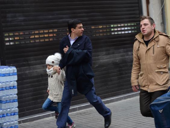 People flee the scene of an explosion on the pedestrian Istiklal avenue in Istanbul on March 19, 2016.