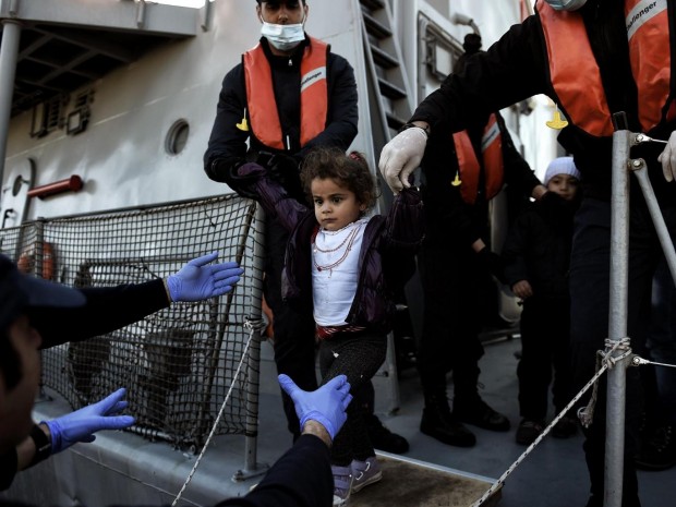 A migrant girl looks on upon arrival at the northern island of Lesbos after crossing the Aegean sea with other migrants and refugees from Turkey. AFP