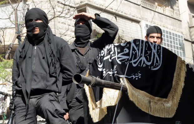 (FILES) A picture taken on October 25, 2013 shows members of jihadist group Al-Nusra Front taking part in a parade calling for the establishment of an Islamic state in Syria, at the Bustan al-Qasr neighbourhood of Aleppo. Al-Qaeda chief Ayman al-Zawahiri has ordered on November 8, 2013 the disbanding of the main jihadist faction in Syria, the Islamic State of Iraq and the Levant and also stressed that the Al-Nusra Front was the branch of the global jihadist group in Syria.  AFP PHOTO / KARAM AL-MASRI