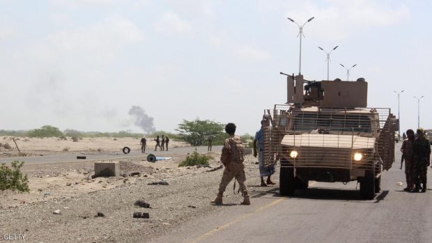 Forces loyal to the Saudi-backed Yemeni president stand guard as smoke billows on a road on the entrance to Abyan province as they take part in an operation to drive Al-Qaeda fighters out of the southern provincial capital, on April 23, 2016  SALEH AL-OBEIDI/AFP/Getty Images