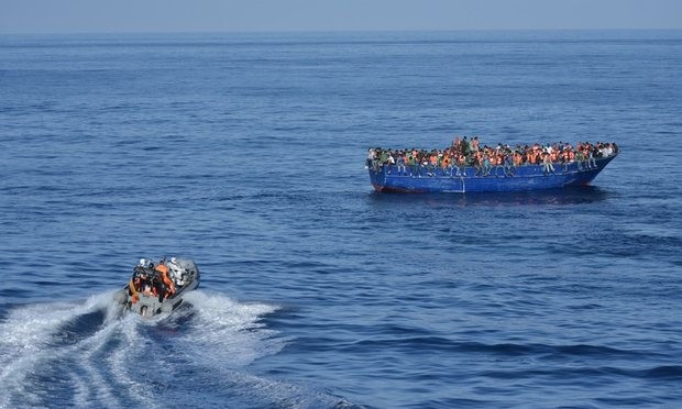 Patrols rescue people from overcrowded boats but critics say smugglers are using them as a ‘ferry service’. Photograph: AFP/Getty Images