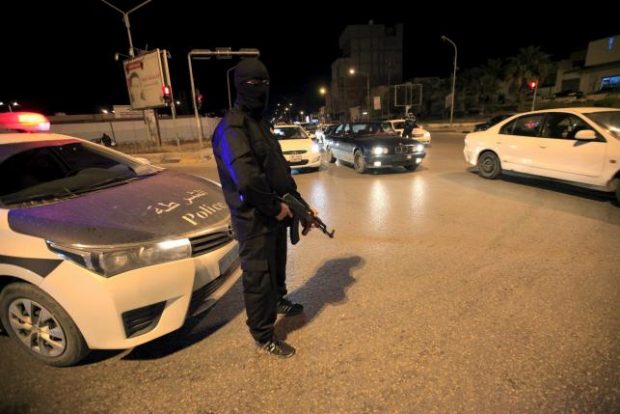 A member of the Special Deterrence Force stands near a car at a checkpoint in Tripoli, Libya March 7, 2016. REUTERS/Ismail Zitouny