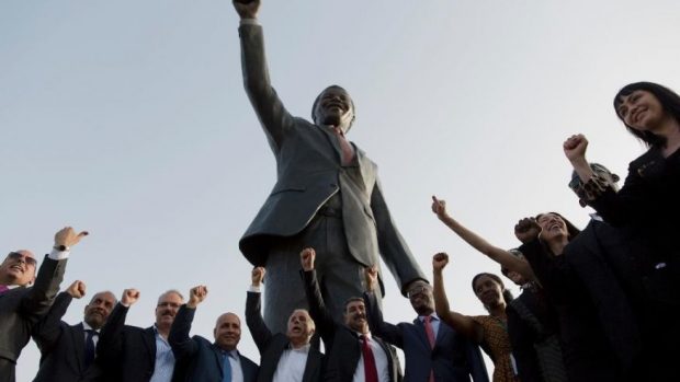  Palestinians pose for a memorial picture with a sculpture of the first democratically elected South African president and anti apartheid leader Nelson Mandela, in the West Bank city of Ramallah, Tuesday, April 26, 2016. Palestinians honored Mandela unveiling his statue on a square in Ramallah, on South Africa's Freedom Day that is observed annually to commemorate the first post apartheid elections held on April 27, 1994. (AP Photo/Nasser Nasser) (The Associated Press) 