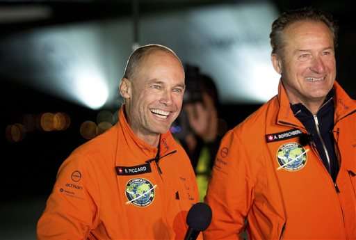 Solar Impulse 2 pilots Bertrand Piccard, left, and Andre Borschberg celebrate after Piccard landed their solar-powered plane at Moffett Field in Mountain View, Calif., on Saturday, April 23, 2016. The solar-powered airplane landed in California on Saturday, completing a risky, three-day flight across the Pacific Ocean as part of its journey around the world. (AP Photo/Noah Berger)
