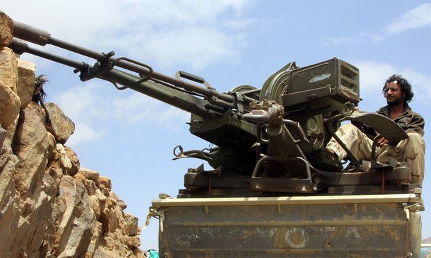 A member of pro-government forces in Yemen sits on a heavily armoured vehicle in Sanaa. Photograph: Nabil Hassan/AFP/Getty Images