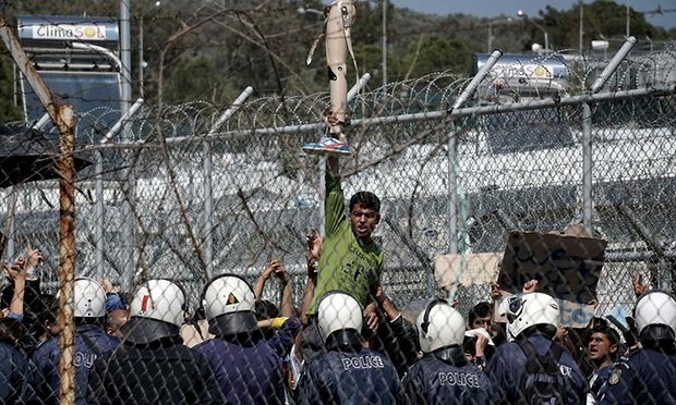 An Afghan man holds a prosthetic leg during a recent protest at Moria detention centre, Lesbos. Photograph: STR/AFP/Getty Images