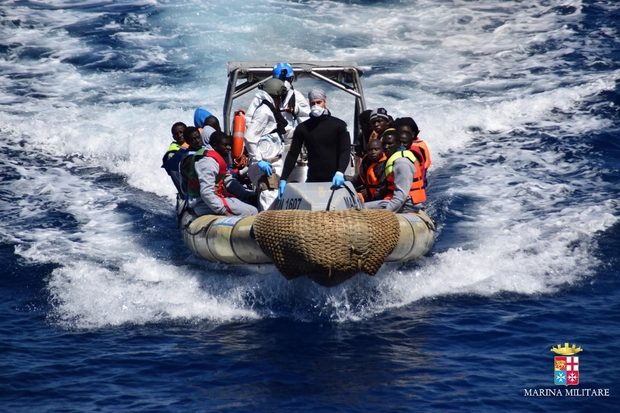 Picture released by the Italian Navy shows a rescue operation of migrants and refugees at sea, off the coast of Sicily, on 11 April 2016 (AFP)