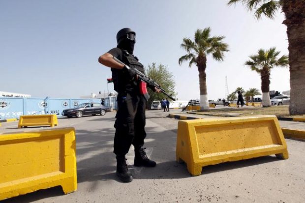 A member of the force assigned to protect Libya's unity government stands at the entrance to where the government has their offices, in Tripoli, Libya April 14, 2016. REUTERS/Ismail Zitouny