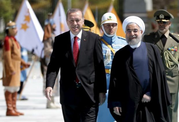 Turkish President Tayyip Erdogan (L) is seen with his Iranian counterpart Hassan Rouhani during a welcoming ceremony at the Presidential Palace in Ankara, Turkey April 16, 2016, in this handout photo provided by the Presidential Palace. REUTERS/Murat Cetinmuhurdar/Presidential Palace/Handout via Reuters