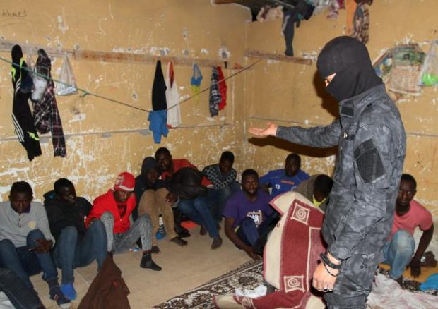 A Libyan security forces officer stands during a raid on illegal migrants at a hideout in Tripoli, Libya, April 17, 2016. L REUTERS/HANI AMARA