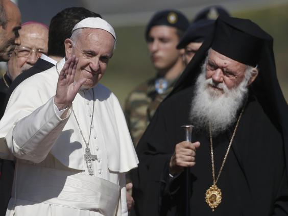 Pope Francis, greeted by Archbishop Ieronimo, arrives on the Greek island of Lesbos on 16 April 2016 (Reuters)