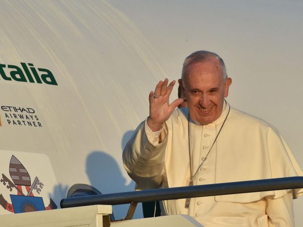 Pope Francis waves to journalists as he boards an plane at Rome's Fiumicino airport, on his way to the Greek island of Lesbos AFP/Getty Images