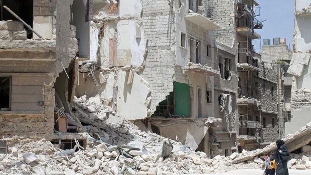 A Syrian woman and two children walk past heavily damaged buildings on May 7, 2014 in the northern city of Aleppo. The evacuation of rebel-held parts of Homs city began today under an unprecedented deal which hands back control to the government less than a month before Syria's presidential election. AFP PHOTO / BARAA AL-HALABI