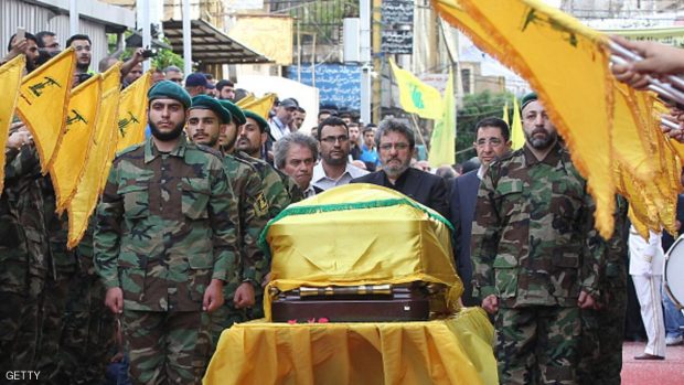 Adnan (C-L) and Hassan Badreddine (C-R), brothers of slain top Hezbollah commander Mustafa Badreddine who was killed in an attack in Syria, mourn next to his casket during the funeral  in the Ghobeiry neighbourhood of southern Beirut on May 13, 2016. Hezbollah announced that Badreddine had been killed in an attack in Syria where the Shiite militant group has deployed thousands of fighters in support of the Damascus regime. The group said it was still investigating the cause of the blast near Damascus airport but it did not immediately point the finger at Israel as it did when the commander's predecessor was assassinated in the Syrian capital in 2008. / AFP / ANWAR AMRO