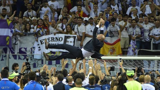 Real Madrid's French coach Zinedine Zidane is thrown into the air by Real Madrid players and staff members after they won the UEFA Champions League final football match over Atletico Madrid at San Siro Stadium in Milan, on May 28, 2016. / AFP / OLIVIER MORIN        (Photo credit should read OLIVIER MORIN/AFP/Getty Images)