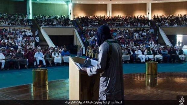  Expand An ISIS lecture on Sharia (Islamic law) at the Ouagadougou complex in Sirte, Libya, where former Libyan leader Muammar Gaddafi once hosted summits with world leaders. The caption in Arabic reads: “Speech by one of the brothers (why we are holding Sharia sessions)” ISIS 2016 image, circulated on social media. 