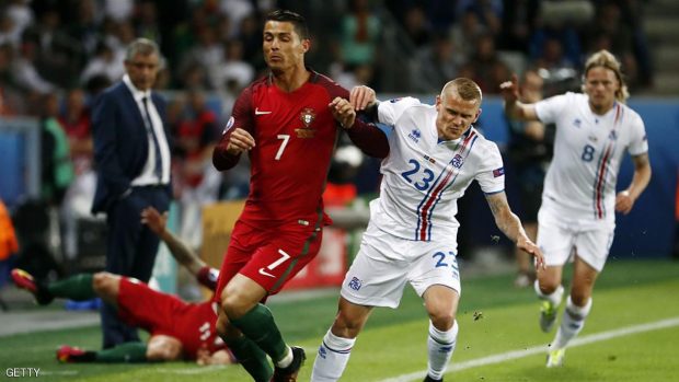 Portugal's forward Cristiano Ronaldo (L) and Iceland's defender Ari Skulason vie for the ball during the Euro 2016 group F football match between Portugal and Iceland at the Geoffroy-Guichard stadium in Saint-Etienne on June 14, 2016. / AFP / ODD ANDERSEN        (Photo credit should read ODD ANDERSEN/AFP/Getty Images)