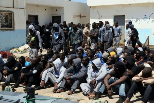 Illegal migrants sit on the dock at the Tripoli port after 117 migrants of African origins, including six pregnant women, were rescued by two coast guard boats off the coast of Libya on June 7, 2016 ©Mahmud Turkia (AFP)