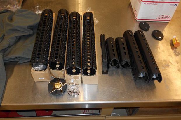 Border officials seized handgun and rifle parts seen in this handout photo in a shipment headed to Iraq. Canada Border Services Agency/Handout