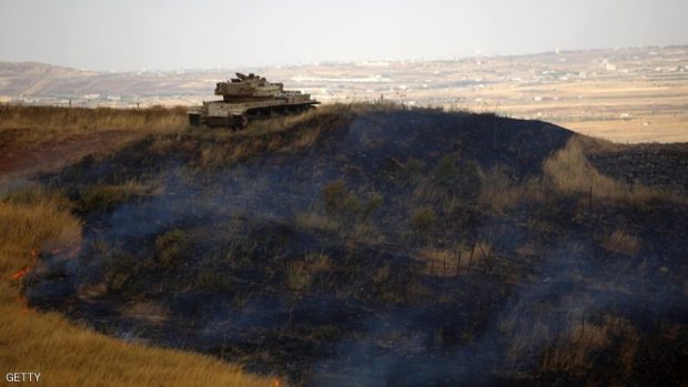 An disused Israeli tank is stationed on a burning mountain side in the El-Rom settlement in the Israeli-annexed Golan Heights on June 28, 2015, after it was hit by a rocket fired from the Syrian side. AFP PHOTO / JALAA MAREY        (Photo credit should read JALAA MAREY/AFP/Getty Images)
