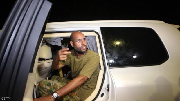 Saif al-Islam Kadhafi, son of Libyan leader Moamer Kadhafi, appears in front of supporters and journalists at his father's residential complex in the Libyan capital Tripoli in the early hours of August 23, 2011. Seif al-Islam, wanted by the International Criminal Court for crimes against humanity and who ICC prosecutor Luis Moreno-Ocampo earlier said had been arrested by the rebels, claimed the insurgents had suffered "heavy casualties" when they stormed Kadhafi's Bab al-Azizya compound in Tripoli. AFP PHOTO/IMED LAMLOUM (Photo credit should read IMED LAMLOUM/AFP/Getty Images)