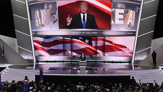 Presumptive Republican presidential candidate Donald Trump introduces his wife Melania Trump (out of frame) to delegates on the first day of the Republican National Convention on July 18, 2016 at Quicken Loans Arena in Cleveland, Ohio. The Republican Party opened its national convention, kicking off a four-day political jamboree that will anoint billionaire Donald Trump as its presidential nominee.  / AFP / Robyn BECK        (Photo credit should read ROBYN BECK/AFP/Getty Images)